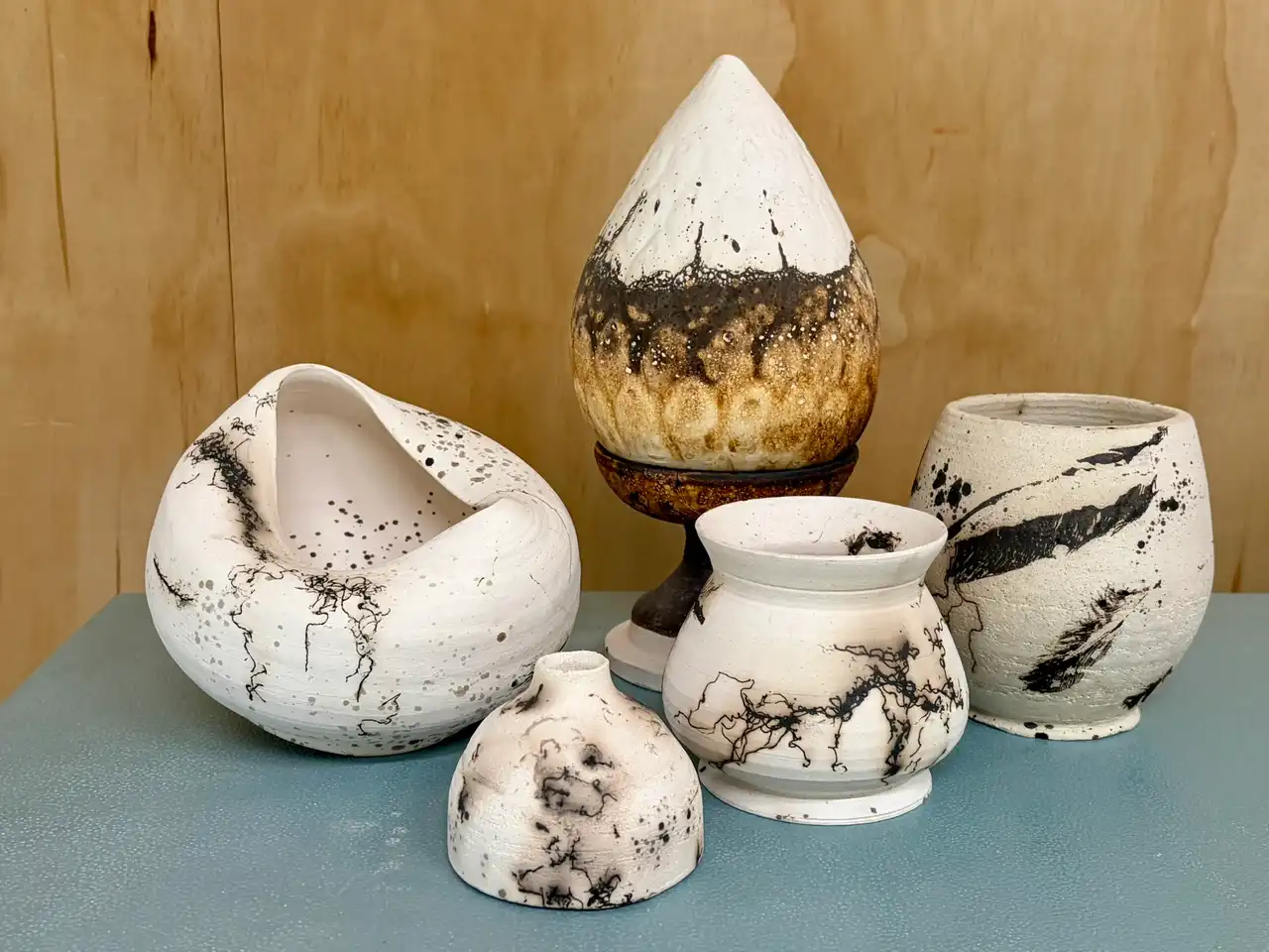 Raku-fired vessels with white crackle glaze and smoky black markings