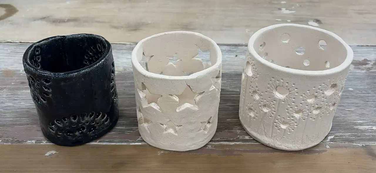 Three pierced ceramic candle holders